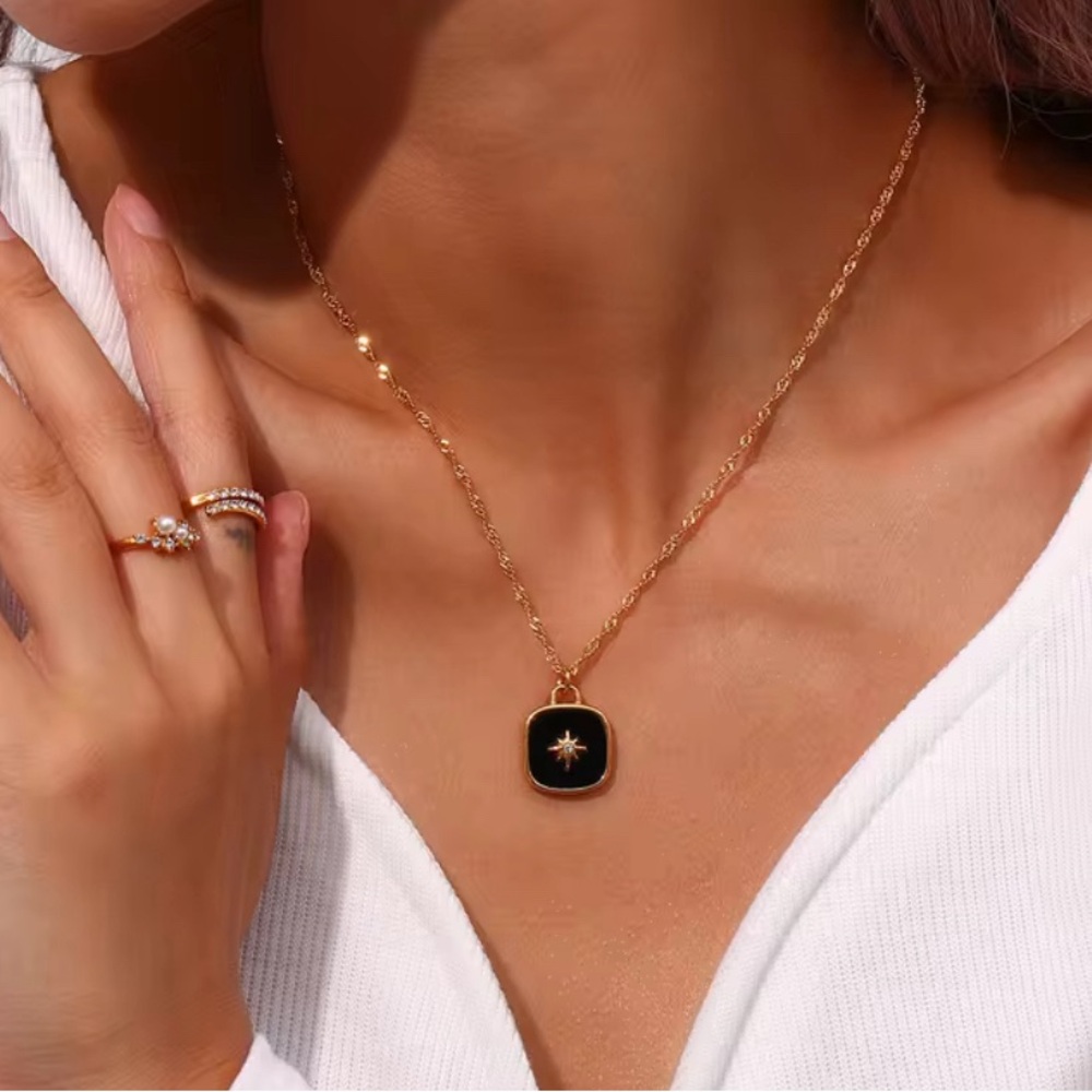 Gold necklace with black pendant